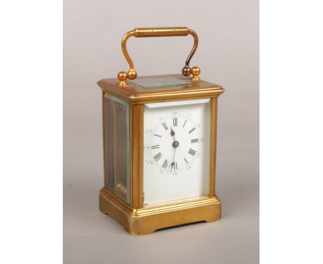 A brass cased 8 day carriage clock of small proportions. With platform escapement and having enamel dial, 11.5cm.  Running. S