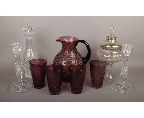 A collection of glassware including a pair of lead crystal candlesticks and an amethyst glass lemonade set etc.  