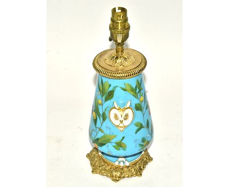 A 19th Century porcelain lamp base in the manner of Minton,   on a bleu celeste ground with opposing owl's heads, owls claw f