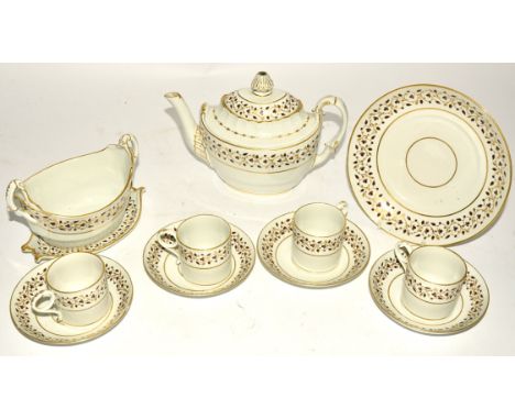 An 18th Century part porcelain tea service,  the teapot of rococo boat shape, on a cream ground with gilt heightening, incise