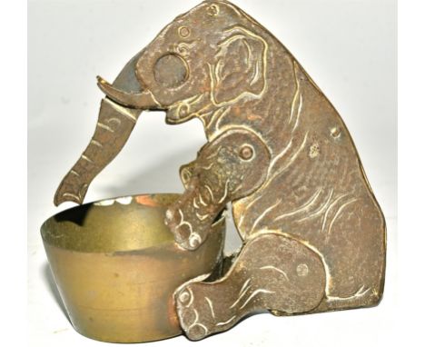 An early 20th Century novelty cigar cutter taking the form of an elephant,  with trunk reaching into a bowl, height 10cm  