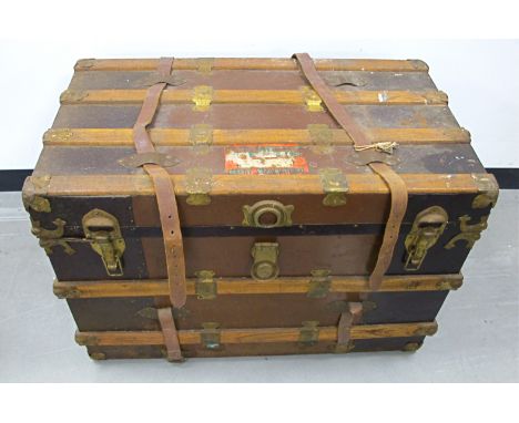 An early 20th Century wooden bound travel trunk,  with lift out tray to the interior and lined with floral patterned paper, C