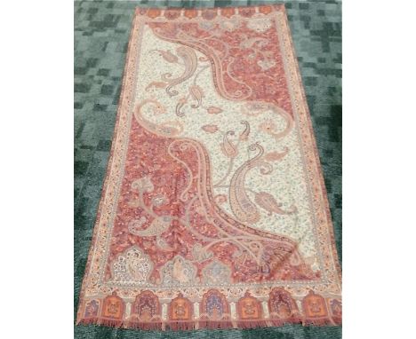 A woven paisley shawl with tasselled ends,  with central foliate motifs and architectural design border of arches and columns