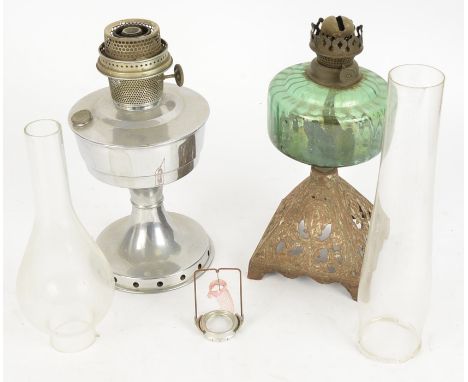 Two British 20th Century oil lamps, one on a cast metal pyramid base with green glass, height 32cm, the other an Aladdin Indu