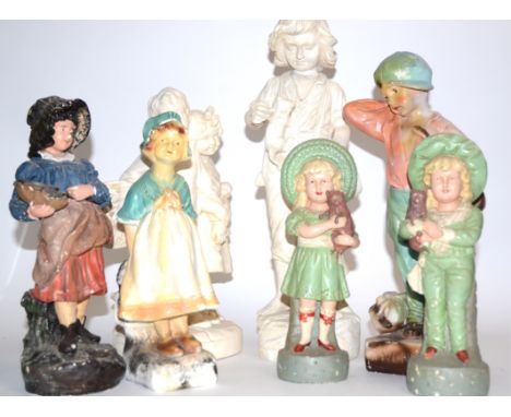 A small quantity of plaster figures of angels and children,  mostly in white, the tallest a boy with kittens in a basket, hei