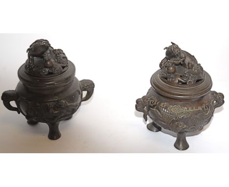 Two Chinese bronze koro, of footed circular form, cast in relief with panels of birds, mythological beasts, the cover with do