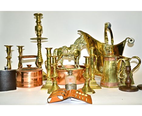 A quantity of brass and treen candlestick holders,  one pair with an inscription to the bottom reading 'made from the roof of