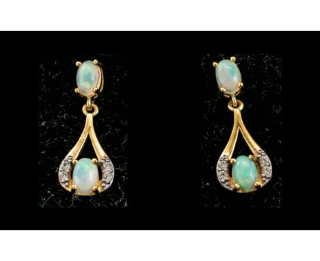 Opal Drop Earrings, each earring having a round cut opal cradled in a loop of gold vermeil and silver, set with white topaz a