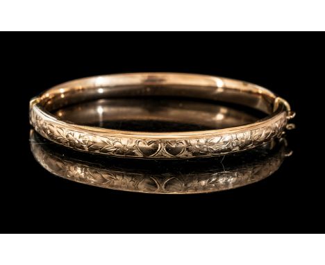 A 9ct Gold Hinged Bangle Floral Engraved Front, Wax Filled. Gross weight 13 grams. 