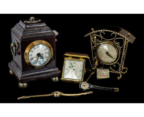 Three Mantle Clocks, comprising  a Victorian brass clock, a Estyma travelling alarm clock with calendar, and a vintage wooden