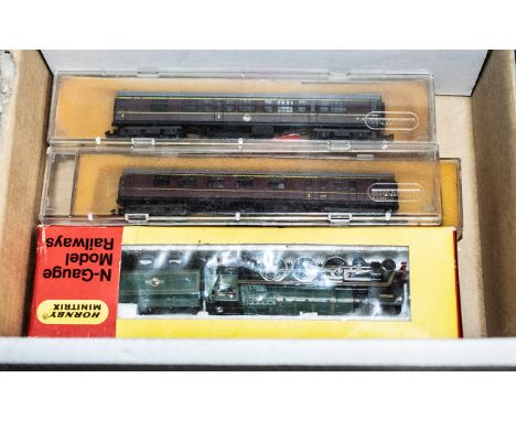 Hornby N gauge interest. Minitrix N203 engine boxed, with two large carriages and four small carriages. 