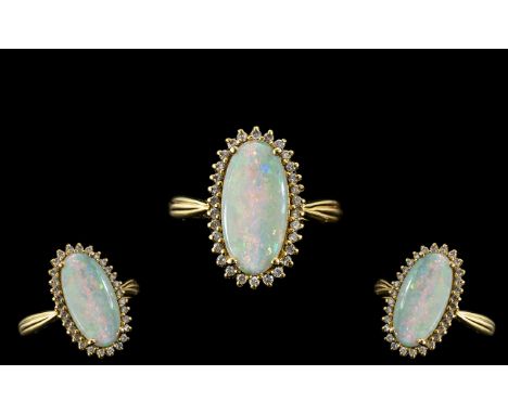 18ct Gold Attractive Opal and Diamond Set Dress Ring full hallmark for 750 to interior of shank. The oval shaped opal of exce