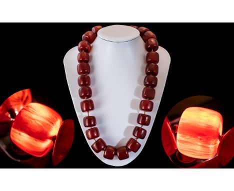 A Faux Cherry Amber Barrel Bead Necklace, each bead individually knotted.  Length 60 cm.  Weight 220 grams.  Good large beads