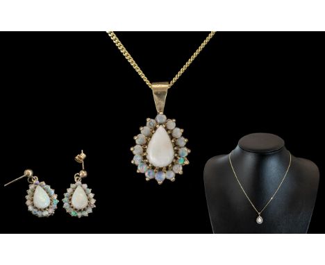 A 9ct Opal Pendant and Earring Set each set with a central pear shaped opal, surrounded by round cut opals.  The pendant incl