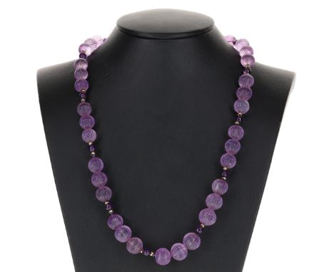 Amethyst carved bead necklace. Measures approx. 62cm in length. Weighs in total 75g