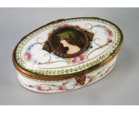 'SEVRES' PORCELAIN OVAL TRINKET BOX painted autour with pink roses and foliate scrolls on a white ground with foliate banded 