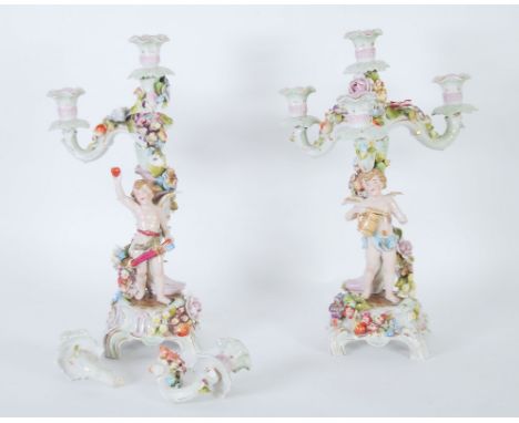 PAIR OF EARLY TWENTIETH CENTURY GERMAN FLORAL ENCRUSTED PORCELAIN FOUR LIGHT CANDELABRA, painted in colours and gilt and each