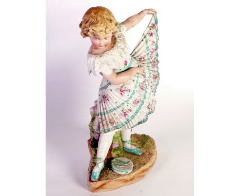 A LATE NINETEENTH CENTURY GERMAN BISQUE FIGURE of a little girl dancing, a tambourine at her feet, 15 3/4" (40cm) high 