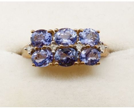 A 9 carat gold ring set six tanzanites, size N to O 