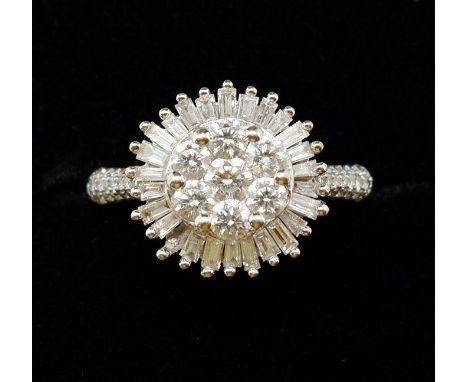 An 18 carat gold diamond cluster ring set seven brilliant cut diamonds in baguette cut surround, size R to S, 7.4g, table 1.3
