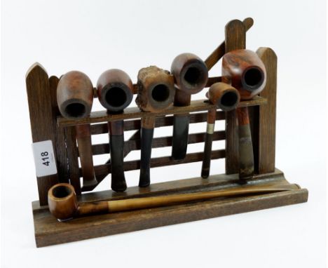 A 'Gate' pipe rack with six pipes plus a church warden pipe 