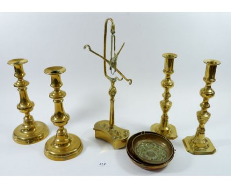 Two pairs of brass candlesticks and a brass set of balance scales 