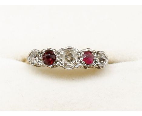 An 18 carat gold and platinum set ring with ruby and three diamonds (one ruby replaced), size K 