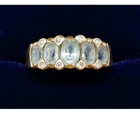 A 9 carat gold ring set five graduated aquamarines, 3.4g, size P to Q 