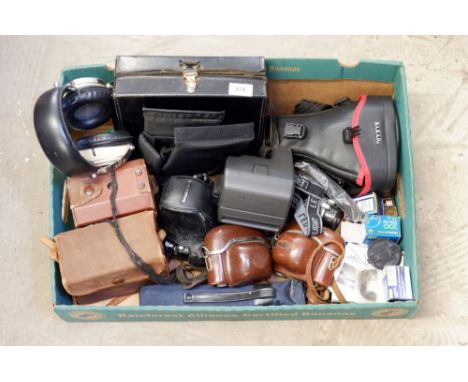 A group of bird watching equipment including camera and headphones and various old cameras 