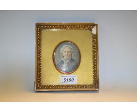 English School (19th century), a portrait miniature, of a lady, half-length, wearing a lace cap, watercolour on ivory, oval, 