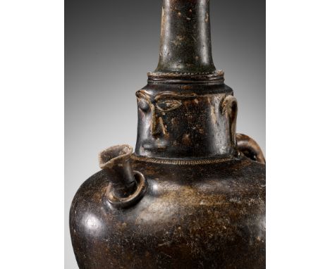 A BROWN-GLAZED STONEWARE JAR WITH A HUMAN FACE, ANGKOR PERIODKhmer, mid-12th century. The globular body supported on a thick 