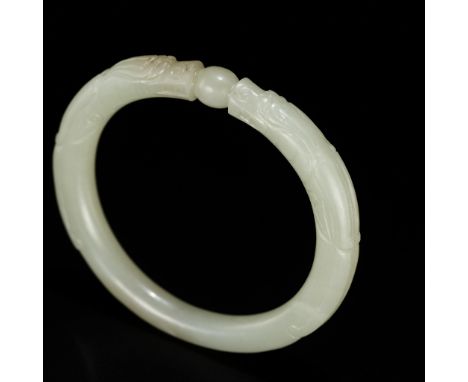 A PALE CELADON JADE 'DRAGON' BANGLE, CHINA, 19TH CENTURYOf circular form, finely carved in the form of two chilong confrontin