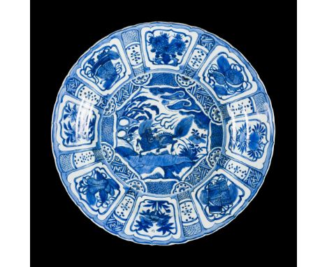 A MONUMENTAL BLUE AND WHITE 'KRAAK' CHARGER, WANLI PERIODChina, 1572-1620. The rounded sides supported on a short foot and ri