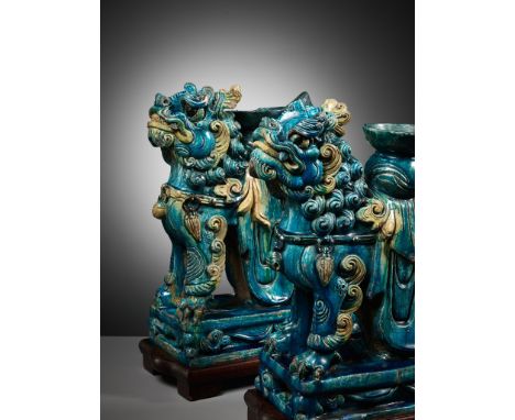 A MASSIVE PAIR OF TURQUOISE AND CREAM-GLAZED 'BUDDHIST LION' STANDS, MING DYNASTYExpert's note: The zhadou-form vases on the 