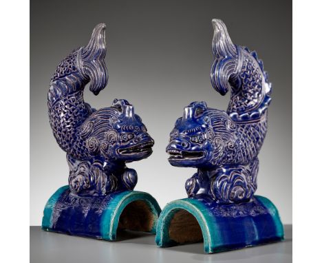 A PAIR OF AUBERGINE AND TURQUOISE-GLAZED 'DRAGON-CARP' ROOF TILES, MING DYNASTYChina, 15th-16th century. Each dragon-carp poi