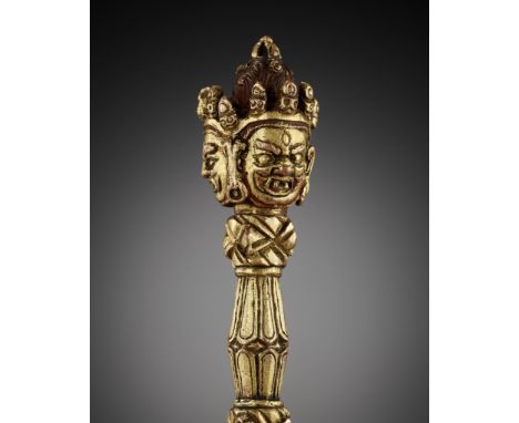 AN IRON AND GILT COPPER ALLOY VAJRAKILA PHURBU, TIBET, 18TH CENTURYThe tripartite ritual dagger issuing from the mouth of a m