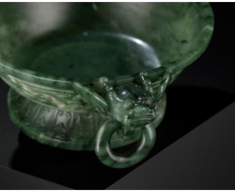 A SPINACH-GREEN JADE MARRIAGE BOWL, CHINA, 18TH CENTURYThe deep, gently rounded sides rise from a tall, flared foot, flanked 