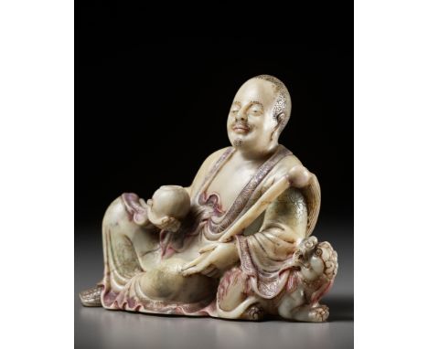 A BAIFURONG SOAPSTONE FIGURE OF XIAOSHI LUOHAN WITH A BUDDHIST LION, EARLY QING DYNASTYExpert's note: The present lot depicts