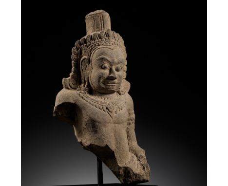 A SANDSTONE BUST OF A DEMON, ASURA, ANGKOR PERIODThe Asuras are a class of demons within Indic religions. They are described 