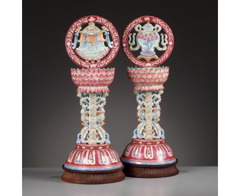 A PAIR OF LARGE RUBY-GROUND FAMILLE ROSE BUDDHIST EMBLEM ALTAR ORNAMENTS, QING DYNASTYChina, 19th century. Each finely modele