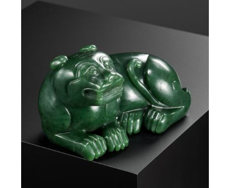 A RARE SPINACH-GREEN JADE FIGURE OF A TIGER, SECOND HALF OF THE QIANLONG PERIODChina, c. 1760-1795. Carved from a large bould