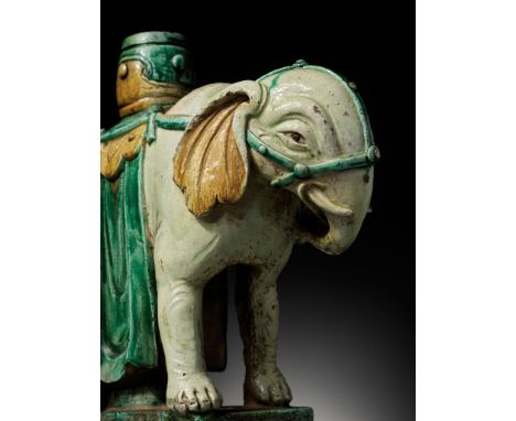 A SANCAI-GLAZED 'ELEPHANT' CANDLEHOLDER, MING DYNASTYChina 15th-17th century. Standing foursquare on a rectangular base, the 