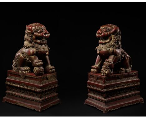 A PAIR OF MONUMENTAL GILT AND RED LACQUERED WOOD FIGURES OF BUDDHIST LIONS, LATE QING DYNASTYChina, 19th century. Both modele