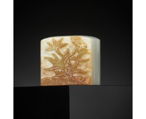 A WHITE AND RUSSET JADE 'EGRET AND LOTUS' ARCHER'S RING, QING DYNASTYChina, 1644-1912. Finely carved to one side in low relie