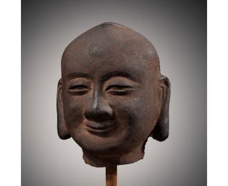 A CAST-IRON HEAD OF A LUOHAN, SONG DYNASTYChina, 960-1279. Finely cast with a serene expression and heavy-lidded eyes below r