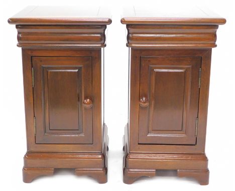 A pair of continental mahogany bedside cabinets, each with a moulded top above a baize lined drawer and a panel door with tur