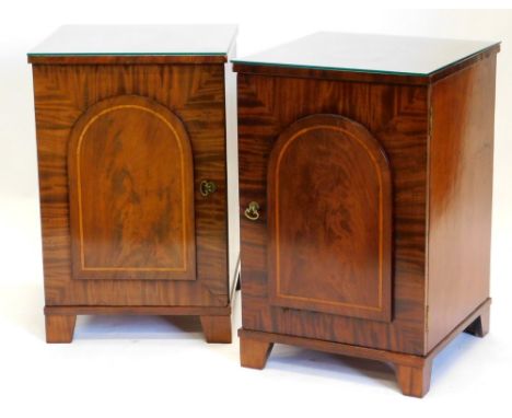 A pair of 19thC figured mahogany pedestals, each with a raised panelled door on bracket feet, 73cm high, 47cm wide, 48cm deep