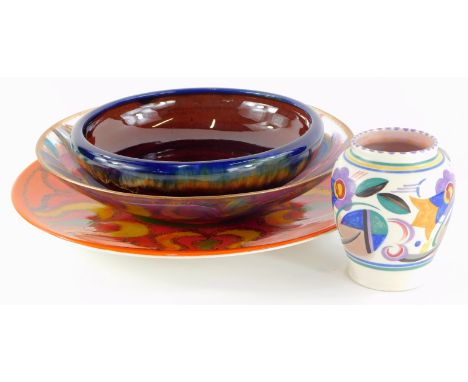 A Poole Pottery Delphis charger, decorated in shades of orange, green, yellow and red, stamped R to reverse, 35cm diameter,  