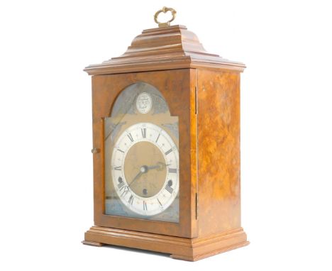 An Elliott mantel clock in walnut and burr walnut case, the arch dial stamped Tempus Fugit, with Westminster chime, on bracke
