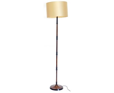 A slender metal standard lamp, painted to simulate wood on a circular base, 173cm high overall.